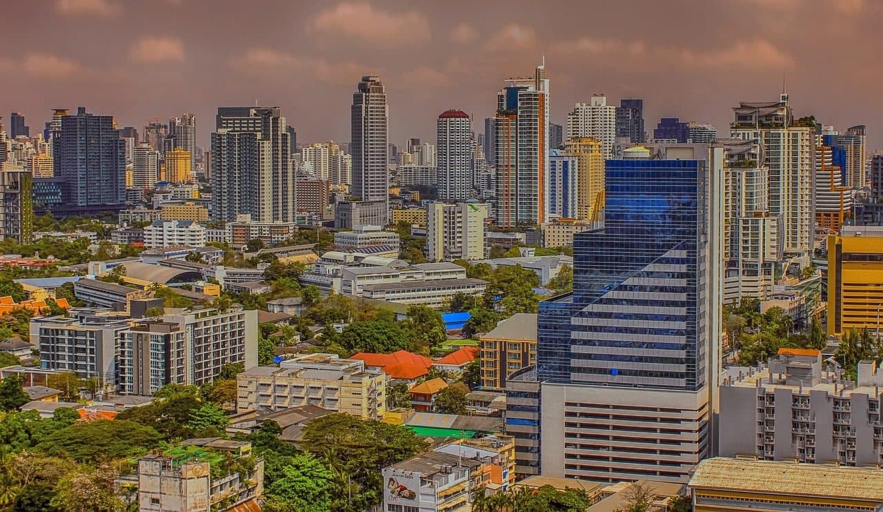 Bangkok's skyline seen from above, with towers and low-rise streets below